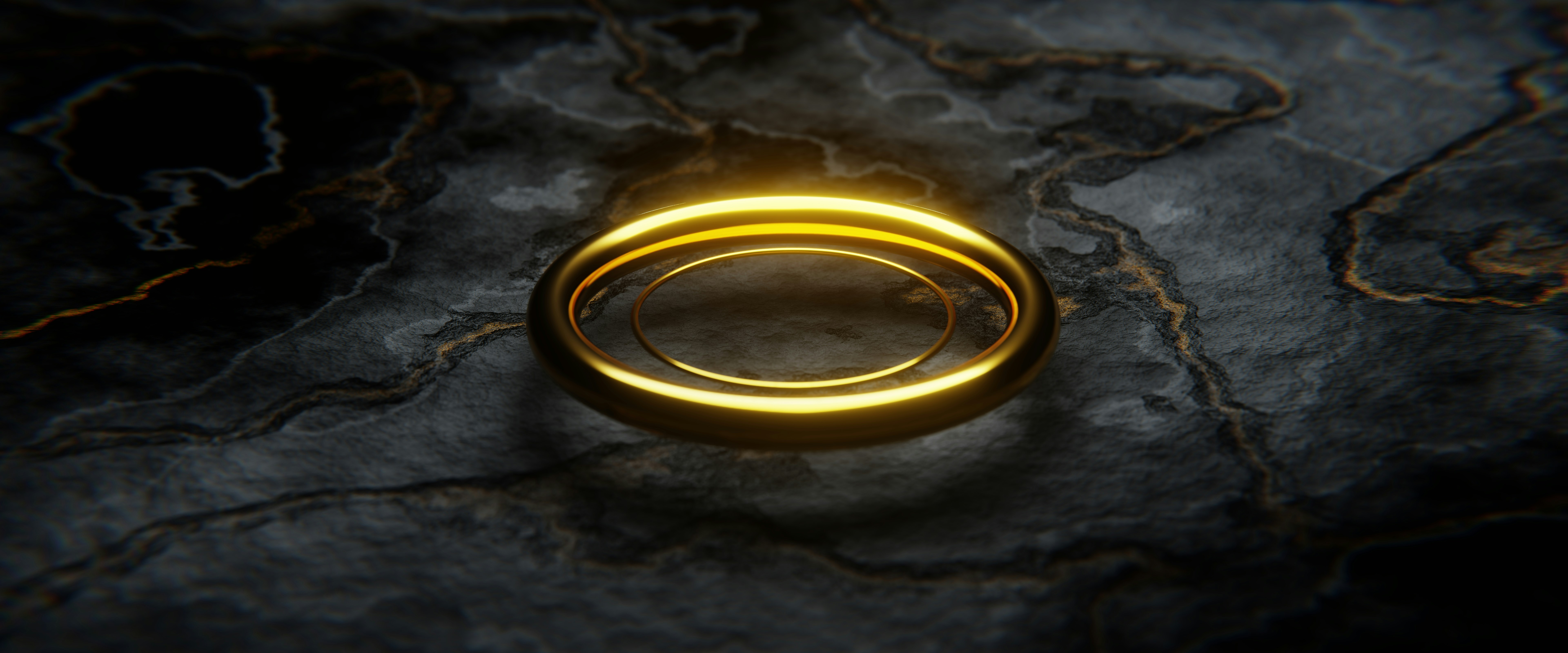 a couple of gold rings sitting on top of a rock